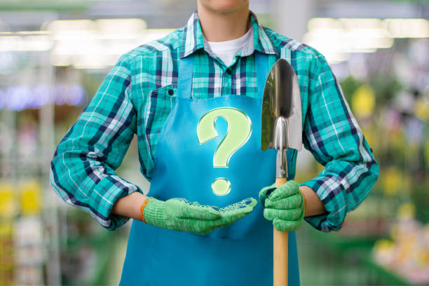 Gardener shows the question on blurred background.