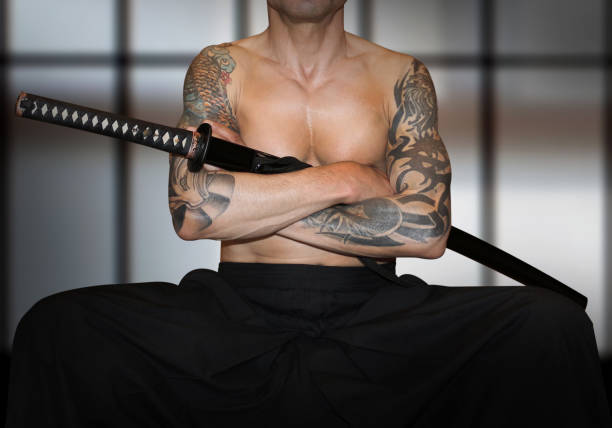 Ninja's Body Tattooed naked samurai's revenge. Brave samurai and katana sword in the japan dojo. The samurai who clasped his hands. Honored warrior is waiting enemies. chest tattoo men stock pictures, royalty-free photos & images