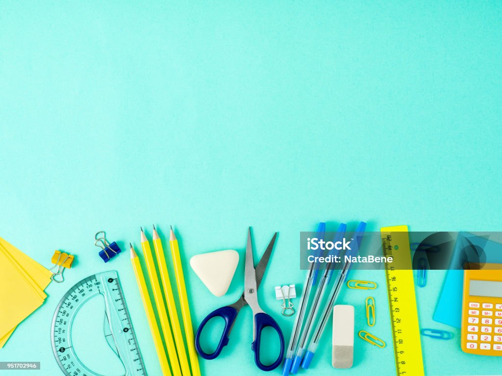 Top view of modern bright blue office desktop with school supplies on table, empty space for text. Back to school concept. School Supplies Stock Photo