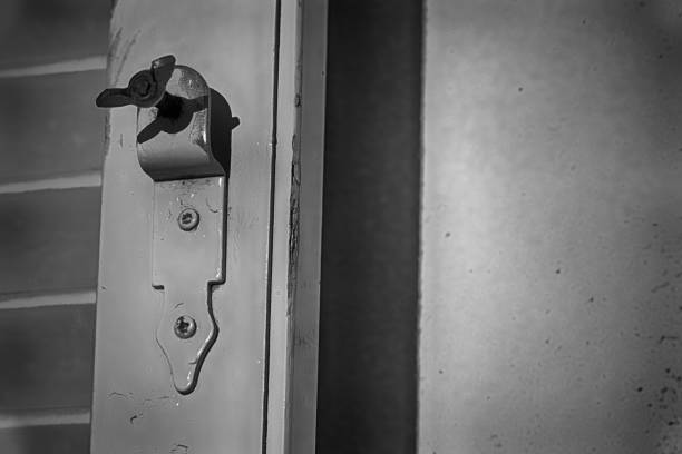 istock Old window latch with already worn white paint. Focused closely and with space for texts. 951703160