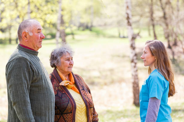 istock Elderly couple and young caregiver 951705658