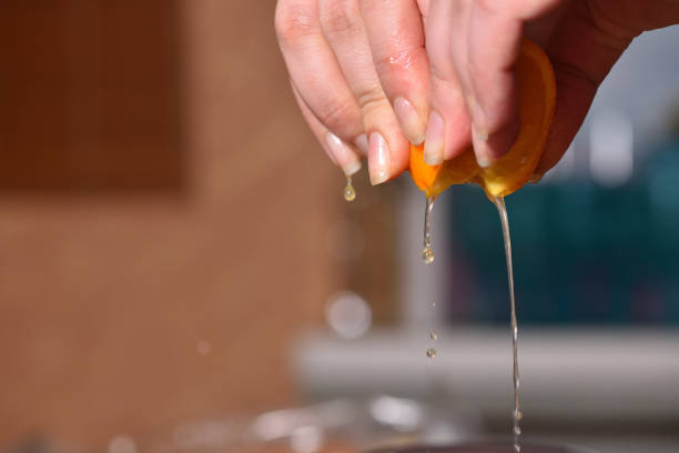 istock Hands squeeze juice from juicy orange 951711780