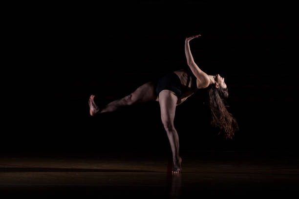 istock beautiful and young dancer dancing in the dark 951715790
