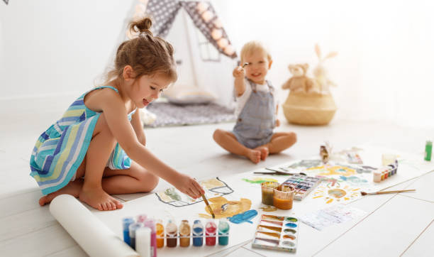 istock happy funny children paint with paint 951732574