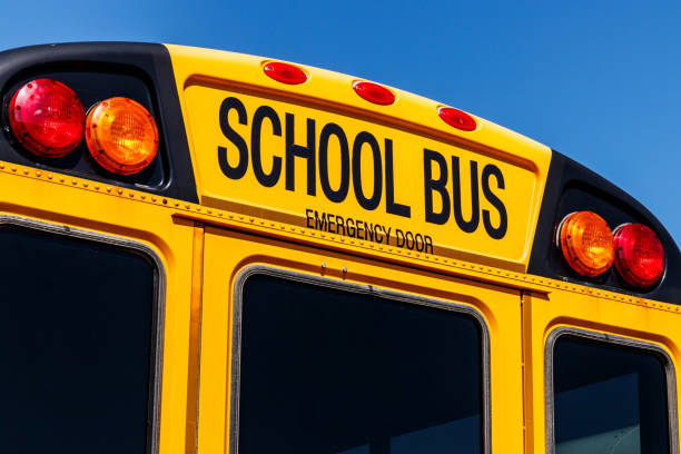 yellow school bus in a district lot waiting to depart for students vi - depart imagens e fotografias de stock