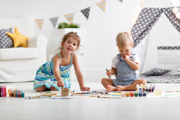 istock happy funny children paint with paint 951735894