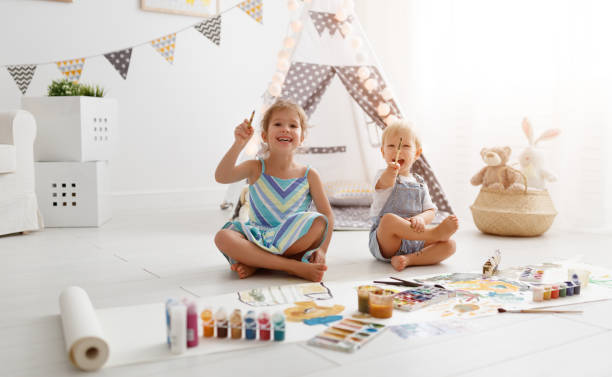 istock happy funny children paint with paint 951735936