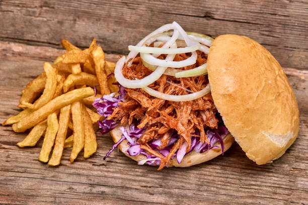 istock Barbeque Pulled pork Sandwich with BBQ Sauce,salad with red cabbageonion,Sauce and Fries on wooden background,Fast food 951741740