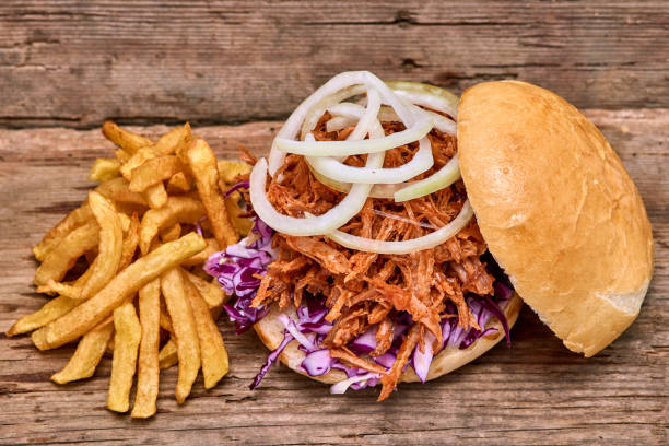 istock Barbeque Pulled pork Sandwich with BBQ Sauce,salad with red cabbageonion,Sauce and Fries on wooden background,Fast food 951741904