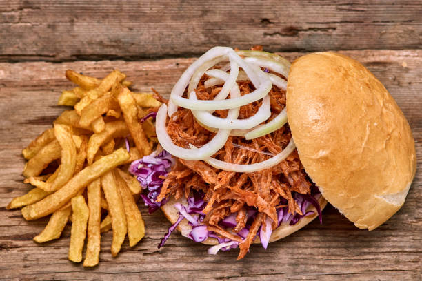 istock Barbeque Pulled pork Sandwich with BBQ Sauce,salad with red cabbageonion,Sauce and Fries on wooden background,Fast food 951741946