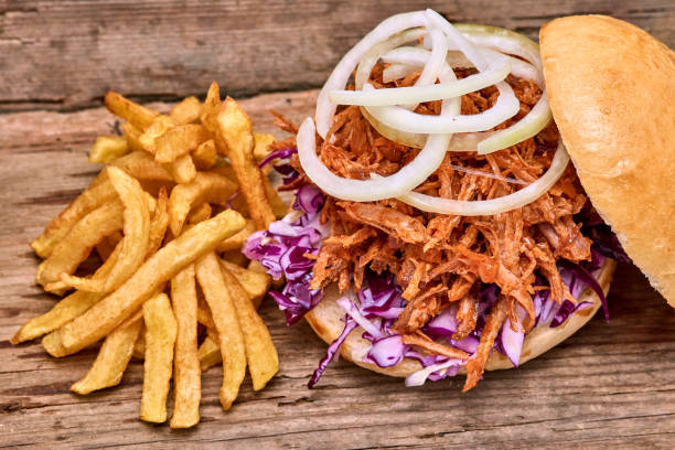 istock Barbeque Pulled pork Sandwich with BBQ Sauce,salad with red cabbageonion,Sauce and Fries on wooden background,Fast food 951742130