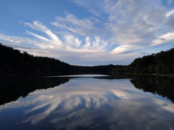 istock Peaceful lake with reflection of cloudy sky 951745052