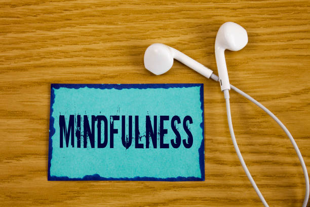 istock Writing note showing  Mindfulness. Business photo showcasing Being Conscious Awareness Calm Accept thoughts and feelings written on Sticky Note Paper on wooden background Handsfree next to it. 951745578