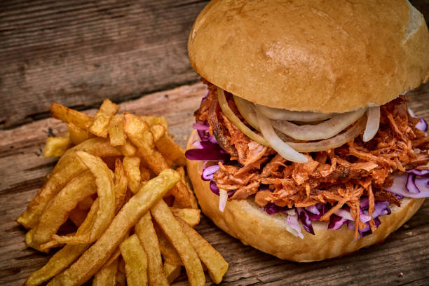 istock Barbeque Pulled pork Sandwich with BBQ Sauce,salad with red cabbageonion,Sauce and Fries on wooden background,Fast food 951745928