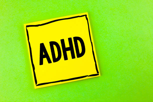 istock Handwriting text Adhd. Concept meaning Learning made easier for children teaching no more a difficult task written on Yellow Sticky Note Paper on the plain background. 951747142
