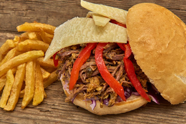 istock Fast food,Barbeque Pulled beff Sandwich with cheese,baked peppers,curry lentils and salad with red cabbage,Sauce and Fries on wooden background 951747234
