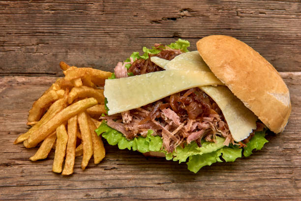istock Barbeque Pulled pork Sandwich with green salad,caramelized onion,cheese,Sauce and Fries on wooden background,Fast food 951751166