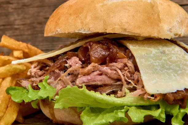 istock Barbeque Pulled pork Sandwich with green salad,caramelized onion,cheese,Sauce and Fries on wooden background,Fast food 951751882