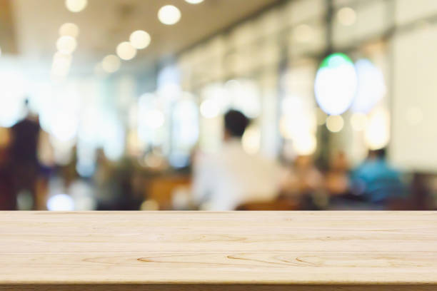 istock Wood table with Restaurant cafe or coffee shop interior with people abstract defocused blur background 951761136