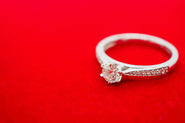 close up luxury wedding diamond ring on red velvet background