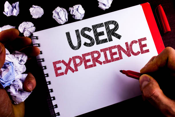 istock Writing note showing  User Experience. Business photo showcasing Customer experience feedback web infrastructure development written by Man on Notepad holding Marker wooden background Paper Balls 951770860
