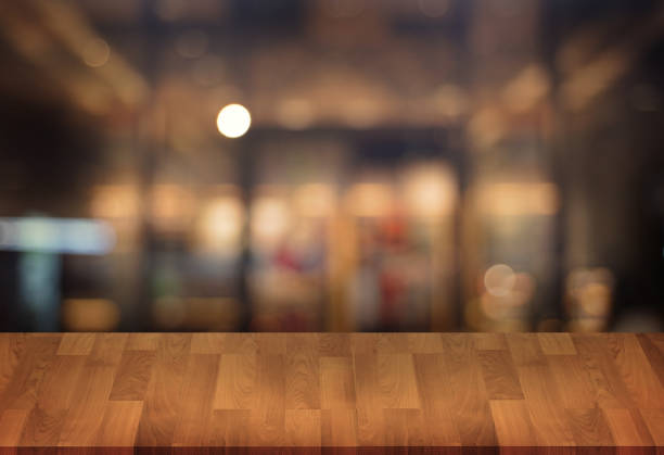 istock Wooden board empty table  cafe, coffee shop, bar blurred background can be used for display or montage your products and Mock up 951780614