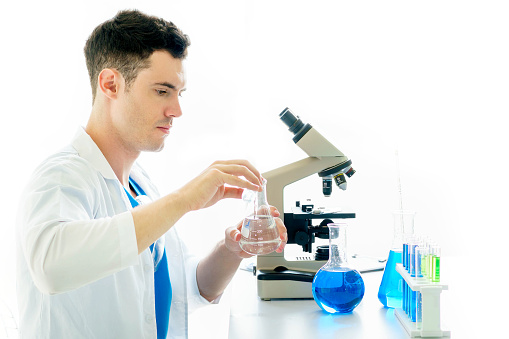Male student of chemistry working in laboratory.