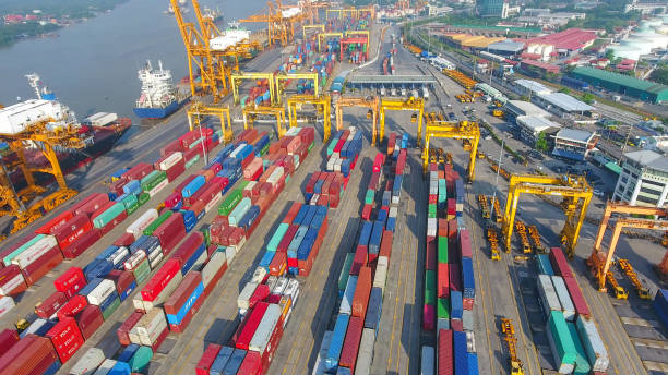 istock Logistics and transportation of Container Cargo ship and Cargo working crane bridge in shipyard 951789508