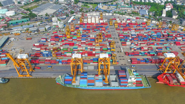 istock Logistics and transportation of Container Cargo ship and Cargo working crane bridge in shipyard 951789578