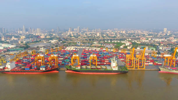 istock Logistics and transportation of Container Cargo ship and Cargo working crane bridge in shipyard 951789582
