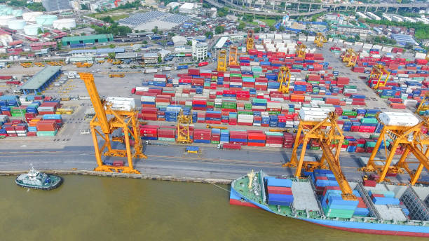 istock Logistics and transportation of Container Cargo ship and Cargo working crane bridge in shipyard 951789612