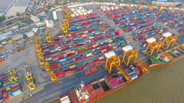 istock Logistics and transportation of Container Cargo ship and Cargo working crane bridge in shipyard 951789814