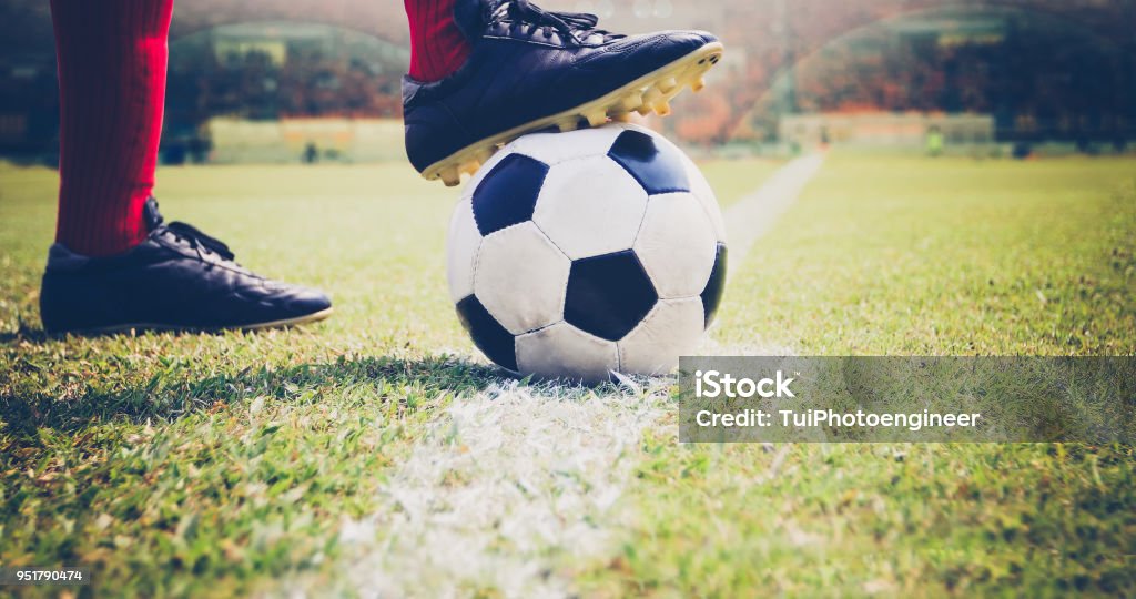 soccer or football player standing with ball on the field for Kick the soccer ball at football stadium Soccer Stock Photo