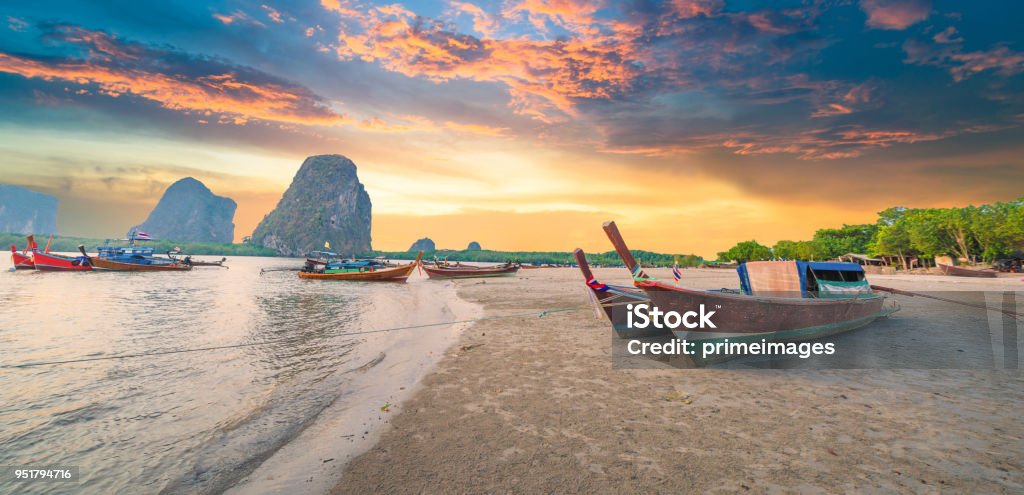 Beautiful sunset at tropical sea with long tail boat in south thailand Thailand Stock Photo