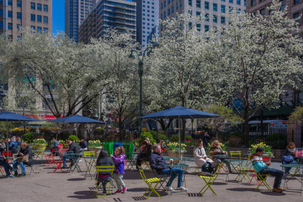 People Seating at the Pedestrianized Area on Broardway Side Walk in front of Macy's stock photo