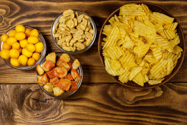 istock Mix of snacks for beer on wooden table 951802408