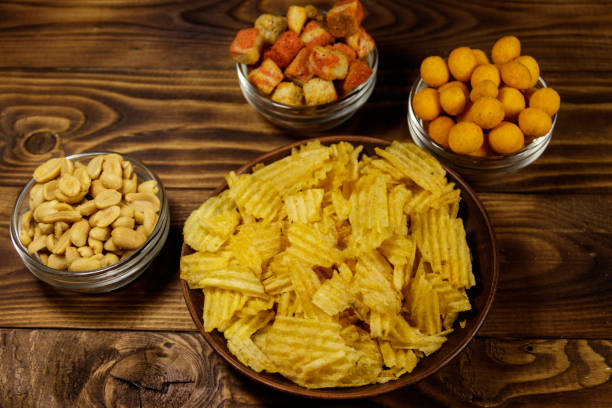 istock Mix of snacks for beer on wooden table 951802410
