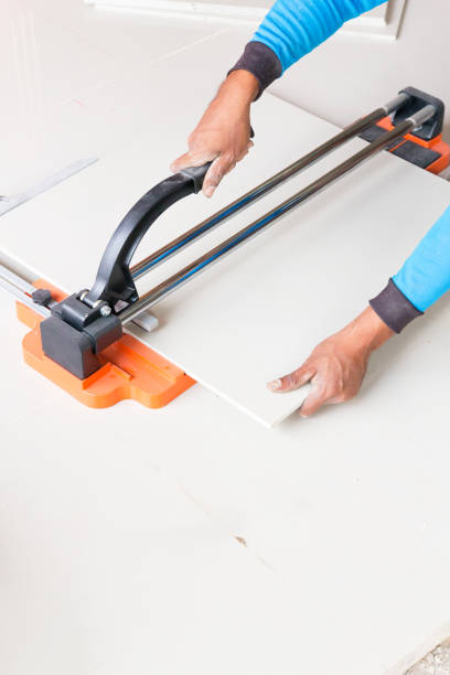 istock Industrial tiler builder worker working with floor tile cutting equipment 951806728
