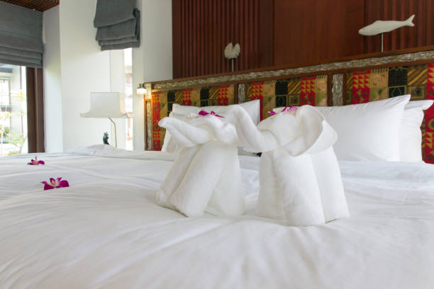 istock Beautiful freshly made bed with elephant towel in the tropics 951806834