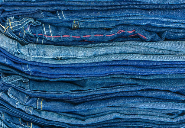 istock jeans stacked on a wooden background 951812568