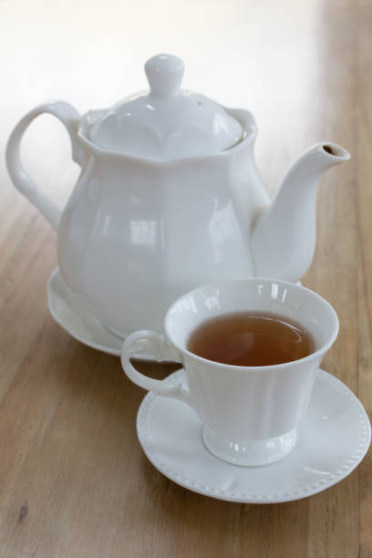 istock Hot black tea in white cup set on wooden table 951816454