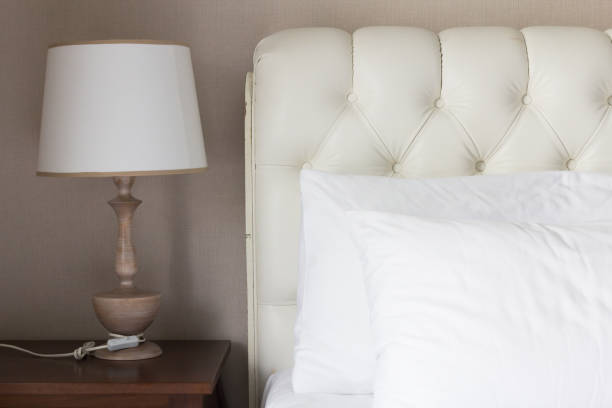 istock White pillow on white luxury bed in bedroom. 951820356