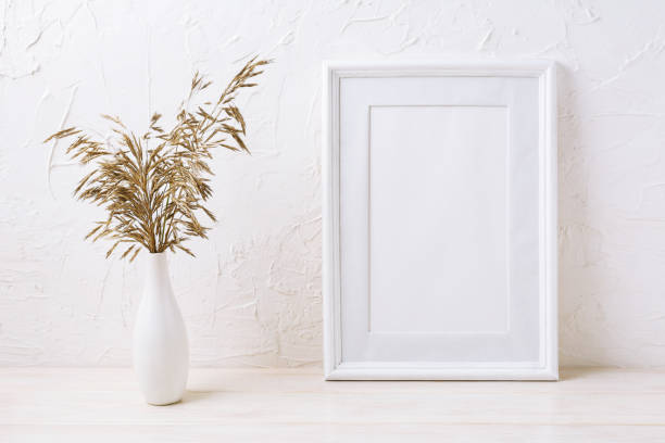 istock White frame mockup with dried grass in vase 951821116