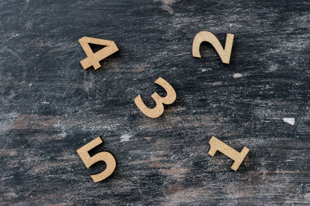 istock Numbers 1, 2, 3, 4, 5 on a dark vintage wooden background. 951823748