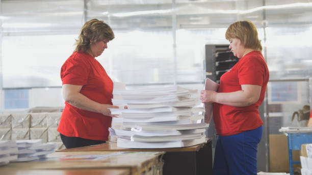 istock Female workers sorting a paper stacks in the typography 951828350