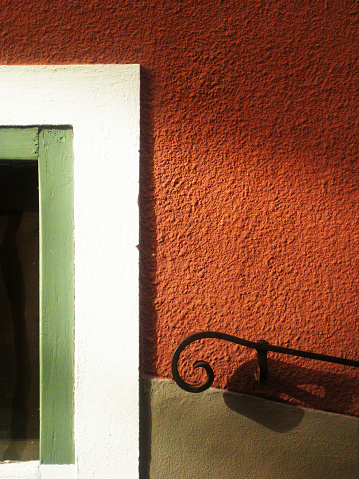 Part of a textured orange concrete wall.