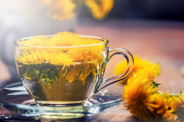istock Cup of dandelion tea on rustic wooden table 951846002