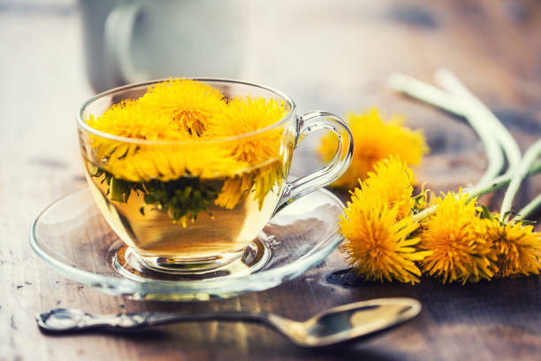 istock Cup of dandelion tea on rustic wooden table 951846014