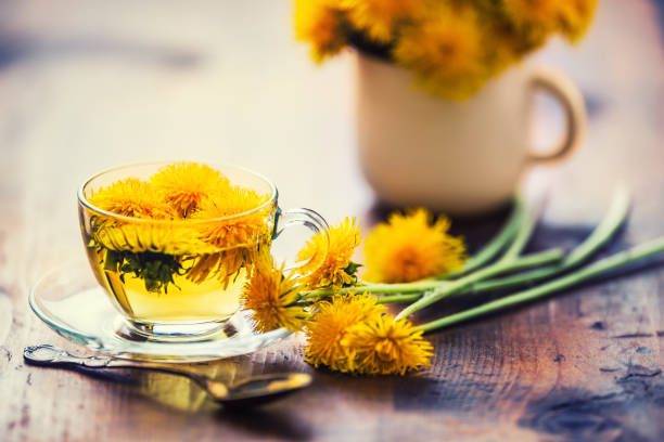 istock Cup of dandelion tea on rustic wooden table 951846038