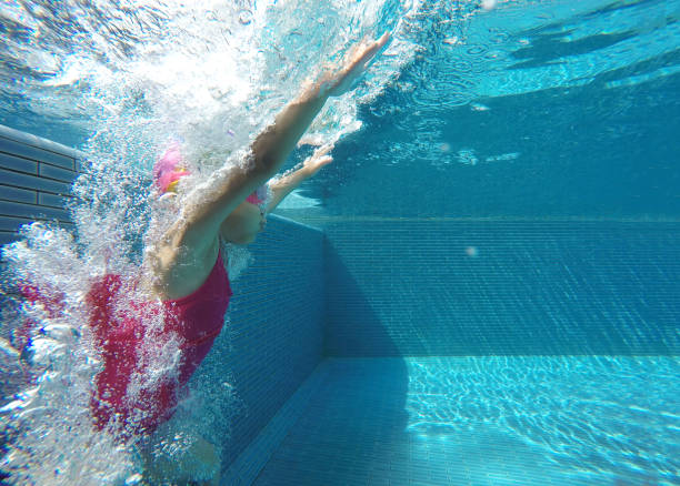 istock happy asian kid swimming underwater in summer. 951847142
